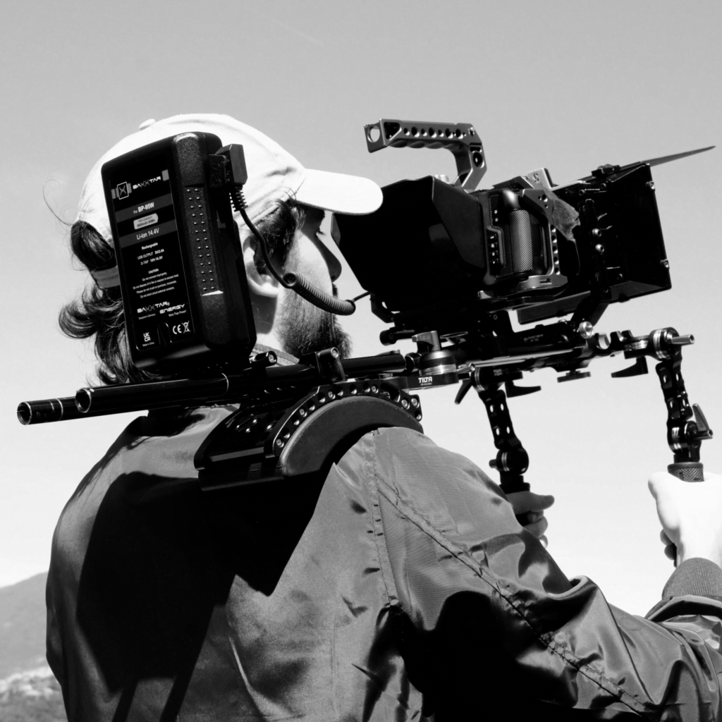 A man holding a camera on his shoulder